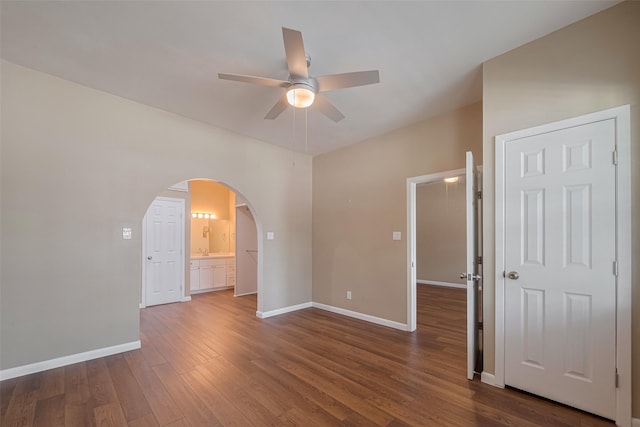 4519 N Main St, Houston, TX 77009 - unfurnished room with ceiling fan, arched walkways, and dark wood-style floors