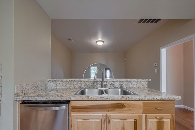 4519 N Main St, Houston, TX 77009 - kitchen with stainless steel dishwasher, light brown cabinetry, light wood-type flooring, and light stone countertops