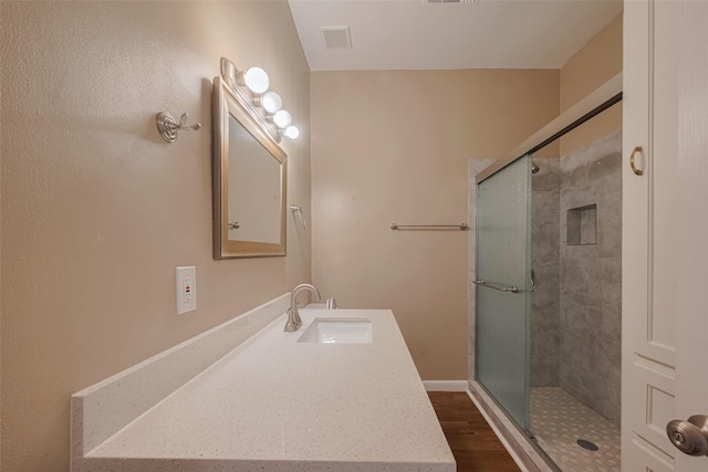 4519 N Main St, Houston, TX 77009 - bathroom with a shower stall, wood finished floors, and vanity