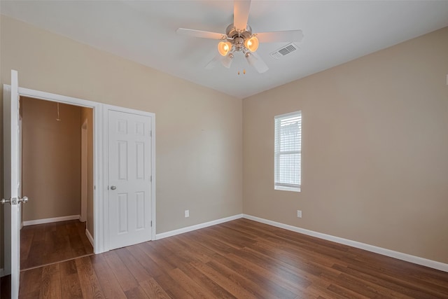 4519 N Main St, Houston, TX 77009 - unfurnished bedroom featuring wood finished floors, attic access, and a ceiling fan