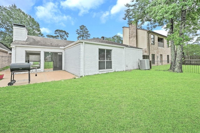 20031 Sunny Shores Dr, Humble, TX 77346 - back of property with a chimney, a patio area, and a shingled roof