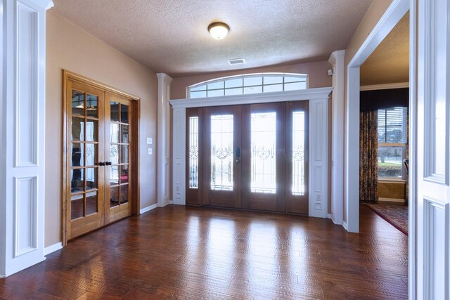 34210 Sanders Ranch Rd, Magnolia, TX 77355 - foyer featuring french doors, a textured ceiling, and dark wood finished floors