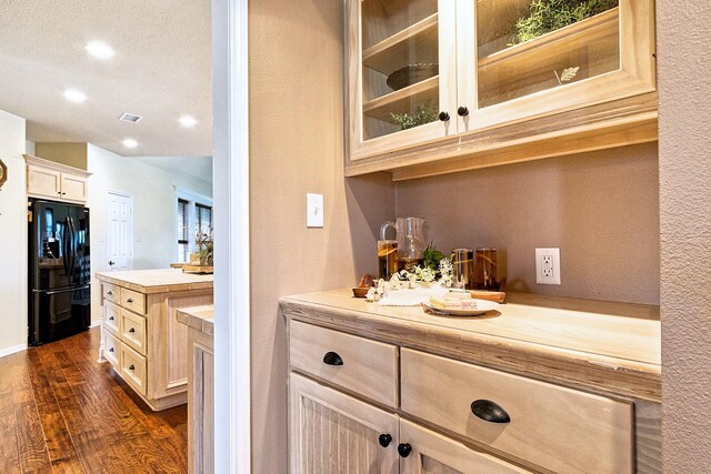 34210 Sanders Ranch Rd, Magnolia, TX 77355 - bar featuring black refrigerator with ice dispenser, dark wood finished floors, recessed lighting, and a textured wall