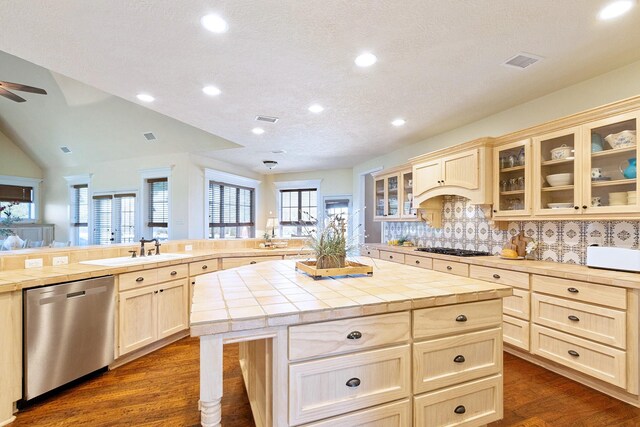 34210 Sanders Ranch Rd, Magnolia, TX 77355 - kitchen with stainless steel dishwasher, a peninsula, tile counters, dark wood-style flooring, and a kitchen island
