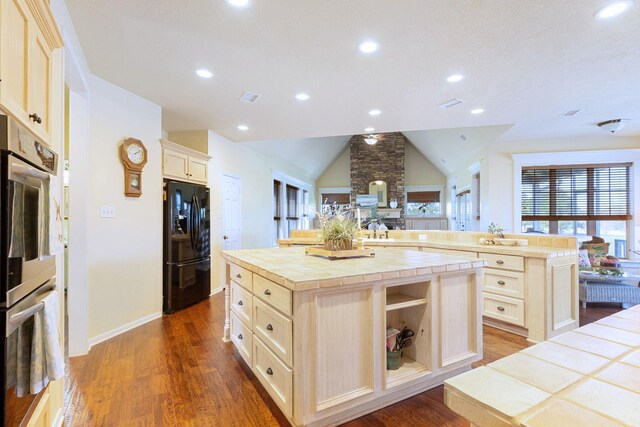 34210 Sanders Ranch Rd, Magnolia, TX 77355 - kitchen with black fridge with ice dispenser, tile countertops, a center island, dark wood-style flooring, and recessed lighting