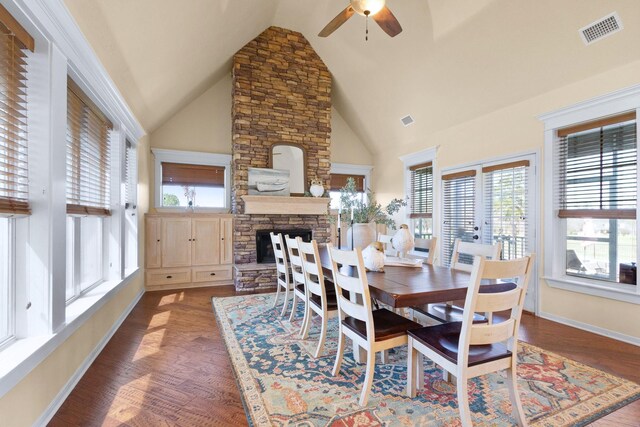 34210 Sanders Ranch Rd, Magnolia, TX 77355 - dining space with ceiling fan, a fireplace, wood finished floors, high vaulted ceiling, and french doors