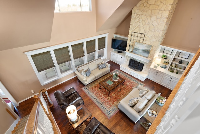 34210 Sanders Ranch Rd, Magnolia, TX 77355 - living room featuring wood finished floors, a stone fireplace, and a high ceiling