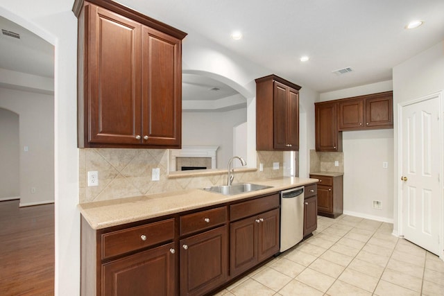 24006 Northshire Ln, Katy, TX 77494 - kitchen with arched walkways, dishwasher, decorative backsplash, recessed lighting, and light tile patterned flooring
