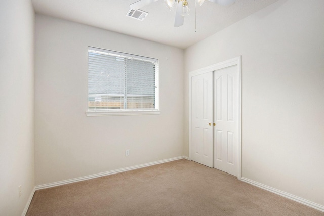 24006 Northshire Ln, Katy, TX 77494 - unfurnished bedroom with light colored carpet, a closet, and a ceiling fan