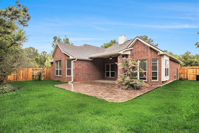 24006 Northshire Ln, Katy, TX 77494 - back of house featuring brick siding, a chimney, a patio, a fenced backyard, and roof with shingles