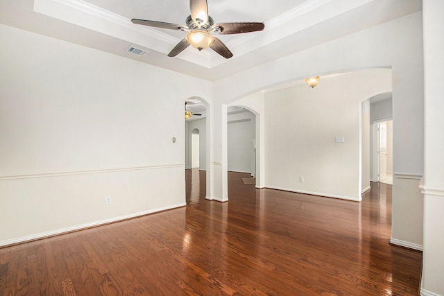24006 Northshire Ln, Katy, TX 77494 - spare room with arched walkways, a ceiling fan, a raised ceiling, wood finished floors, and ornamental molding