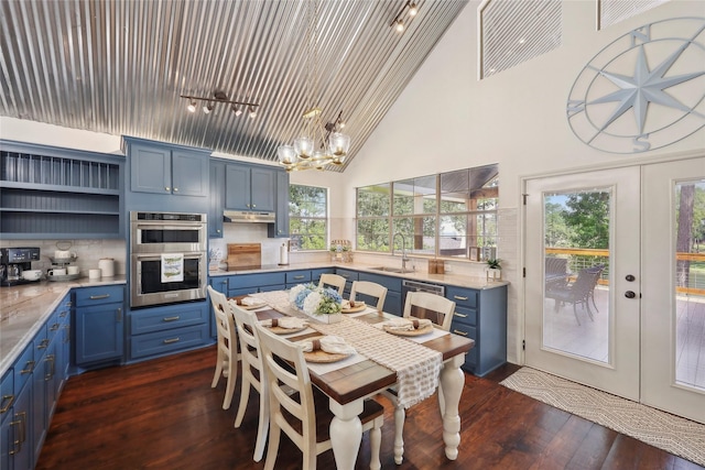 243 Riverbirch, Brookeland, TX 75931 - dining area featuring dark wood-style floors, a chandelier, and high vaulted ceiling