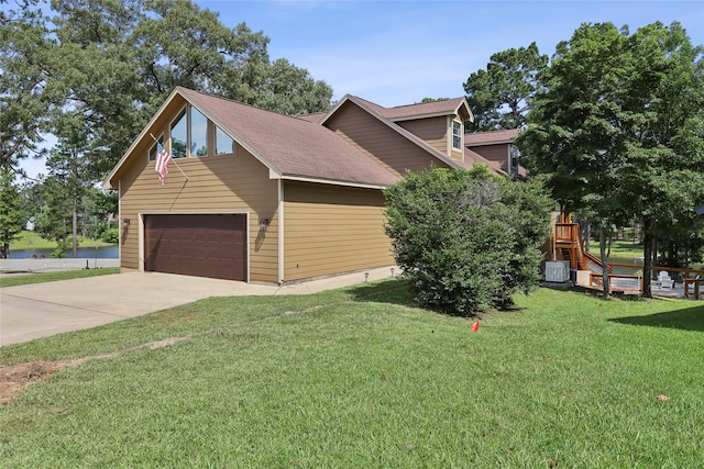 243 Riverbirch, Brookeland, TX 75931 - view of side of property featuring a yard, a garage, concrete driveway, a water view, and roof with shingles