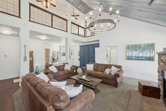 243 Riverbirch, Brookeland, TX 75931 - living room with high vaulted ceiling, a chandelier, a ceiling fan, a stone fireplace, and wood finished floors
