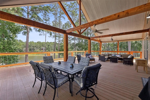 243 Riverbirch, Brookeland, TX 75931 - wooden deck with an outdoor living space, ceiling fan, outdoor dining space, and view of wooded area