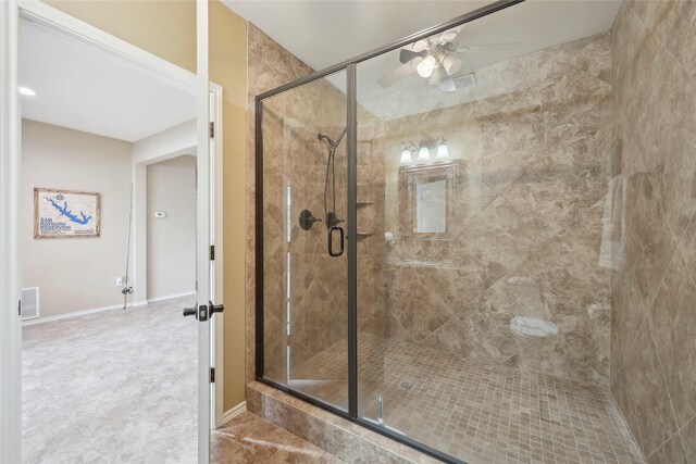 243 Riverbirch, Brookeland, TX 75931 - bathroom with ceiling fan, a shower stall, and tile patterned floors