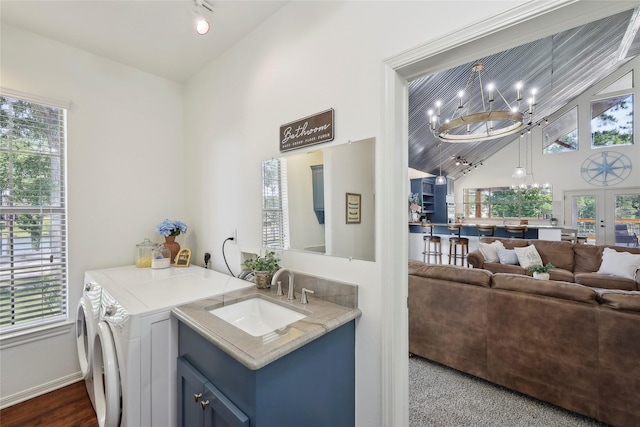 243 Riverbirch, Brookeland, TX 75931 - washroom with separate washer and dryer, a chandelier, a towering ceiling, and french doors