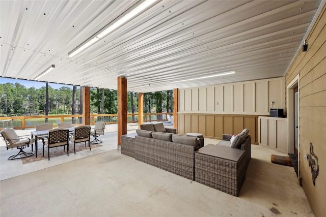 243 Riverbirch, Brookeland, TX 75931 - view of patio with outdoor lounge area, outdoor dining area, and view of wooded area