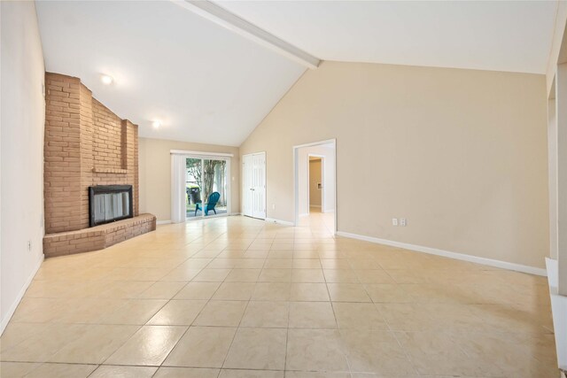 15615 Sandy Hill Dr, Houston, TX 77084 - unfurnished living room featuring light tile patterned flooring, a brick fireplace, beam ceiling, and high vaulted ceiling