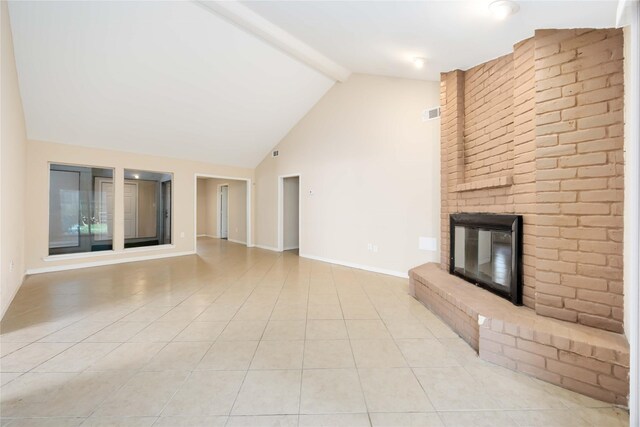 15615 Sandy Hill Dr, Houston, TX 77084 - unfurnished living room featuring a brick fireplace, beamed ceiling, light tile patterned floors, and high vaulted ceiling