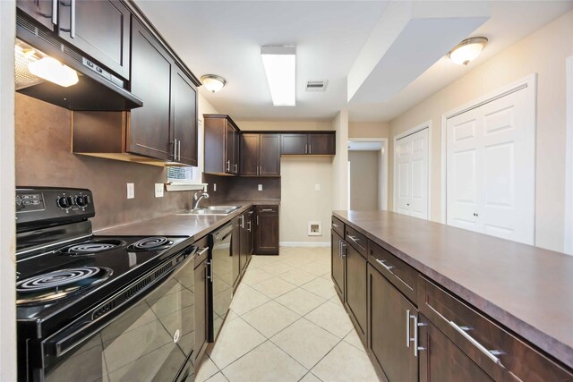 15615 Sandy Hill Dr, Houston, TX 77084 - kitchen featuring black electric range oven, under cabinet range hood, light tile patterned flooring, dark brown cabinets, and stainless steel dishwasher
