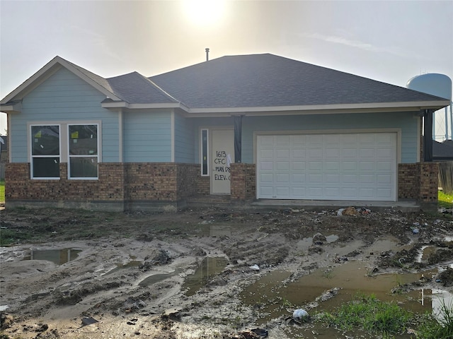 1613 Carefree Cir, Seabrook, TX 77586 - single story home with brick siding, a garage, and a shingled roof