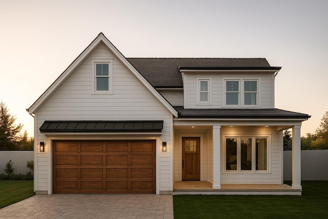 206 Milwaukee St, Houston, TX 77009 - view of front facade featuring decorative driveway, a porch, a standing seam roof, a shingled roof, and a metal roof