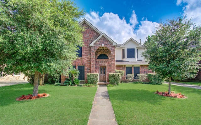 1010 Forestburg Dr, Spring, TX 77386 - traditional home featuring a front yard, brick siding, and stucco siding