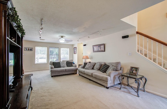 1010 Forestburg Dr, Spring, TX 77386 - living room with rail lighting, light colored carpet, and stairway