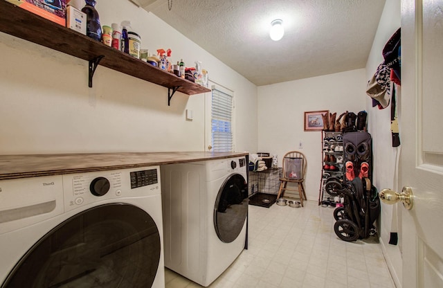 1010 Forestburg Dr, Spring, TX 77386 - laundry area featuring washing machine and clothes dryer and a textured ceiling