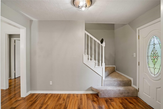 8214 Camborne Ln, Houston, TX 77070 - foyer entrance featuring wood finished floors, stairway, and a textured ceiling