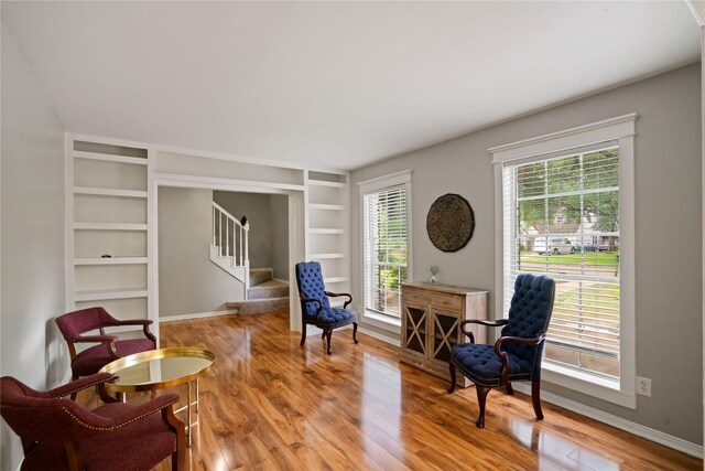 8214 Camborne Ln, Houston, TX 77070 - sitting room featuring light wood finished floors, stairway, and built in features
