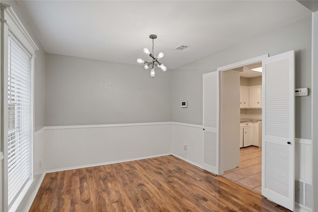 8214 Camborne Ln, Houston, TX 77070 - empty room with a chandelier and wood finished floors