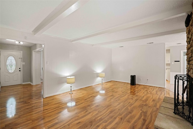 8214 Camborne Ln, Houston, TX 77070 - unfurnished living room featuring beam ceiling and wood finished floors