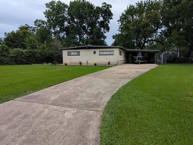 107 Southern Oaks Dr, Lake Jackson, TX 77566 - ranch-style home with concrete driveway, a front lawn, and an attached carport