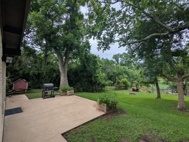 107 Southern Oaks Dr, Lake Jackson, TX 77566 - view of green lawn featuring a patio area and a shed