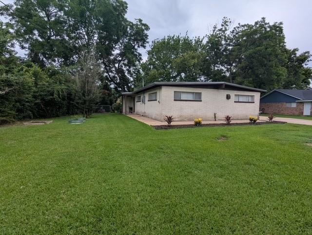 107 Southern Oaks Dr, Lake Jackson, TX 77566 - view of home's exterior featuring a yard and brick siding