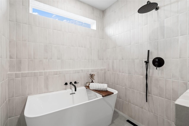 2948 Pitzlin St, Houston, TX 77023 - bathroom featuring tile walls, a soaking tub, and a tile shower