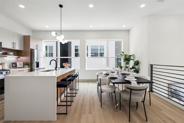2948 Pitzlin St, Houston, TX 77023 - kitchen with stainless steel fridge, gas stove, light wood-style floors, healthy amount of natural light, and recessed lighting
