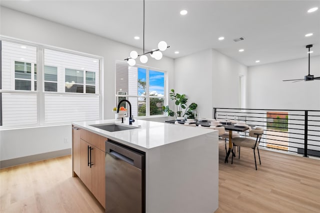 2948 Pitzlin St, Houston, TX 77023 - kitchen with dishwasher, modern cabinets, light wood finished floors, an island with sink, and hanging light fixtures