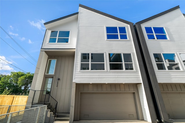 2948 Pitzlin St, Houston, TX 77023 - view of property featuring board and batten siding and an attached garage