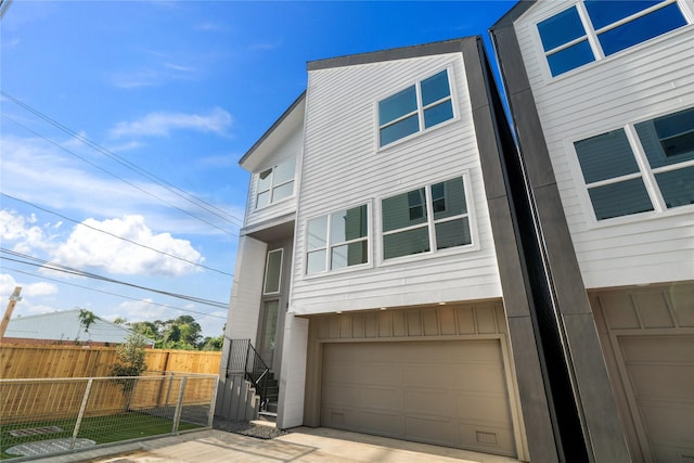 2948 Pitzlin St, Houston, TX 77023 - view of front of house featuring an attached garage and board and batten siding