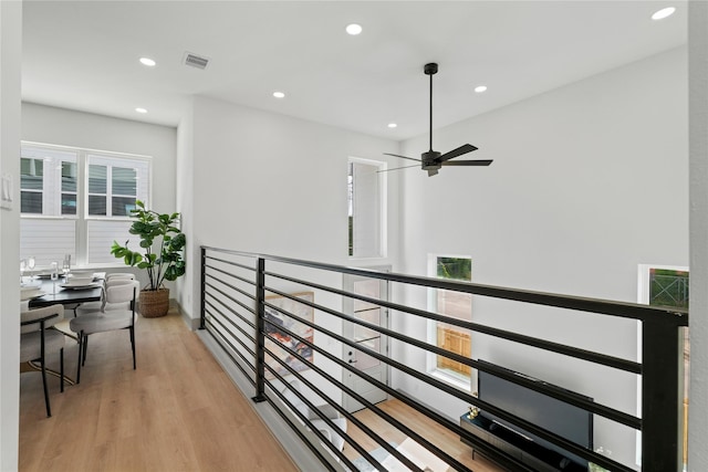 2948 Pitzlin St, Houston, TX 77023 - corridor featuring wood finished floors, recessed lighting, and an upstairs landing