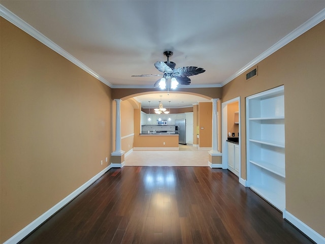 2111 Welch St Unit B109, Houston, TX 77019 - unfurnished living room featuring decorative columns, arched walkways, a ceiling fan, ornamental molding, and built in shelves