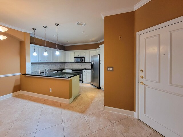 2111 Welch St Unit B109, Houston, TX 77019 - kitchen with appliances with stainless steel finishes, a peninsula, dark countertops, tasteful backsplash, and hanging light fixtures