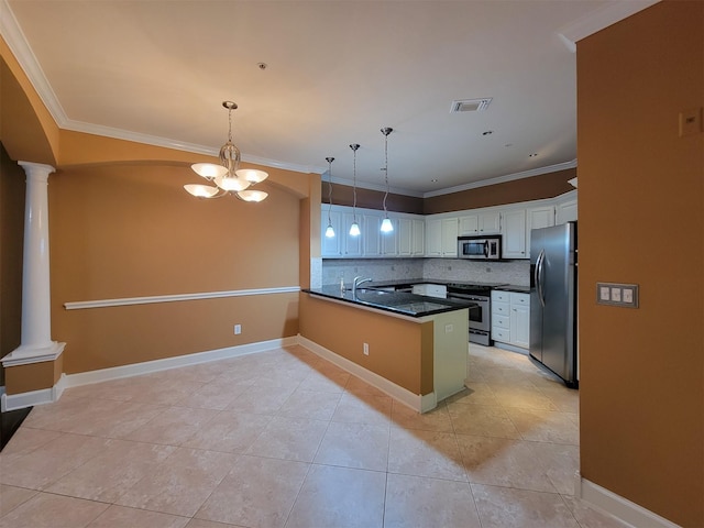 2111 Welch St Unit B109, Houston, TX 77019 - kitchen featuring appliances with stainless steel finishes, ornate columns, a peninsula, dark countertops, and decorative light fixtures
