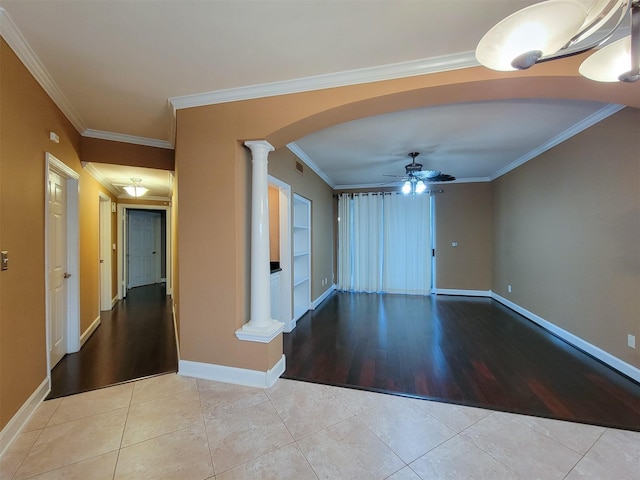 2111 Welch St Unit B109, Houston, TX 77019 - tiled empty room featuring ornate columns, arched walkways, ceiling fan, and ornamental molding