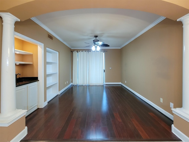 2111 Welch St Unit B109, Houston, TX 77019 - unfurnished living room with ornate columns, a ceiling fan, dark wood-type flooring, crown molding, and built in shelves