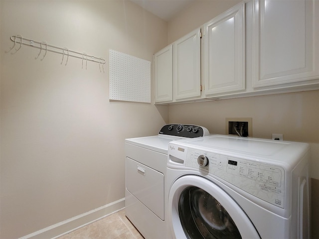 2111 Welch St Unit B109, Houston, TX 77019 - washroom with cabinet space, washer and dryer, and light tile patterned flooring