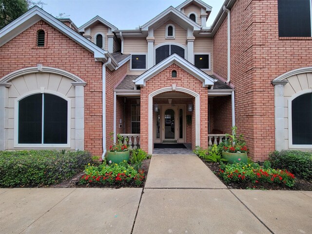 2111 Welch St Unit B109, Houston, TX 77019 - doorway to property featuring a porch and brick siding